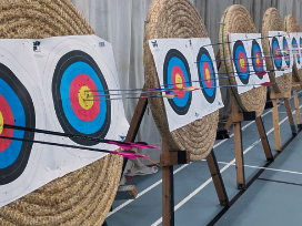 Arrows in straw bosses in the sports hall, from the first indoor sighters of the year.