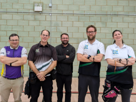 Five Darenteford members stand with their game face on, at the sports hall at Clacton Archers