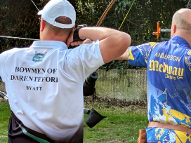 Two archers aiming from the shooting line