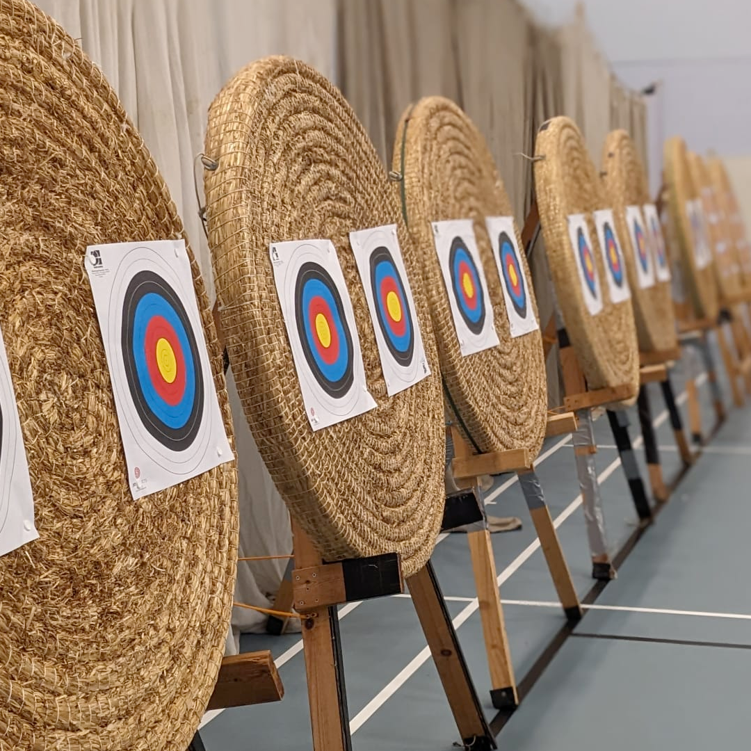 Eight circular bosses made of straw are ready for shooting, with two small target faces on each boss.